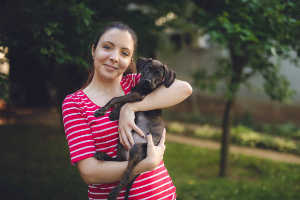 istock Young woman with puppy 1159767362