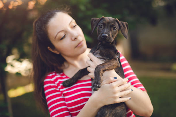 istock Young woman with puppy 1159767389