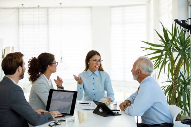 istock Business people having board meeting in modern office 1159767457