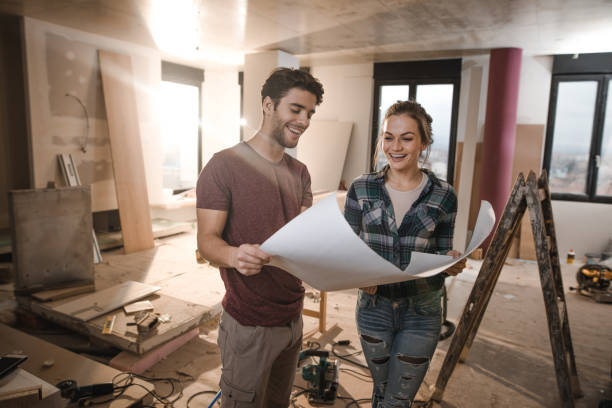 istock Happy couple looking at their housing project on construction site. 1159768827