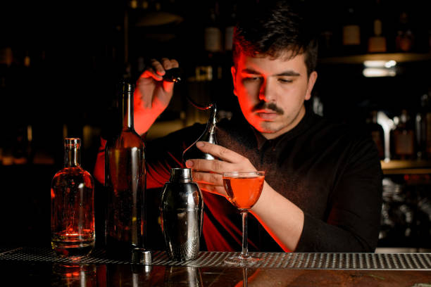 istock Male bartender spraying from the diffuser on the delicious cocktail in the glass 1159769908