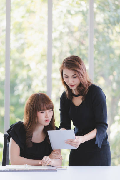 istock TWO BUSINESS LADIES IN OFFICE 1159771379