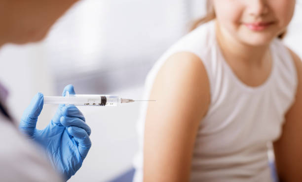 istock Doctor giving an injection to a young patient 1159775254