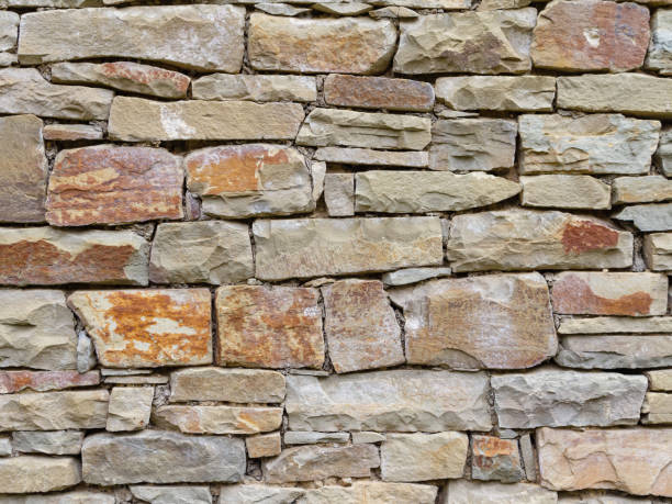 istock Fragment of a wall from a natural stone 1159775778