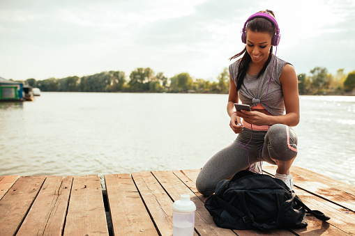 Photo of an athlete woman listening to the music.