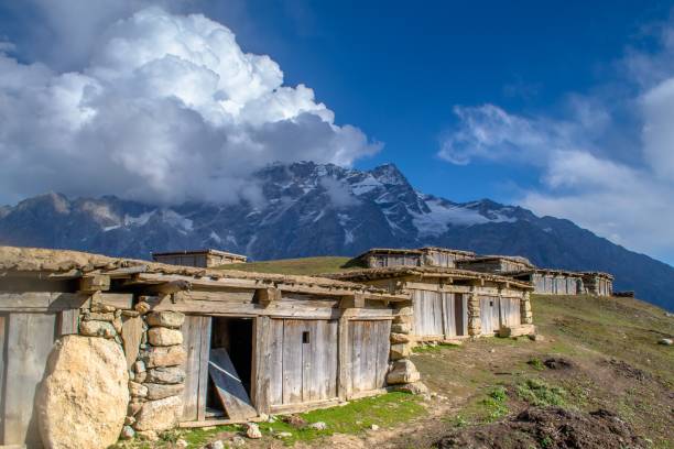 istock Snow capped high mountains alpine meadows and local mountain settlements 1159777171