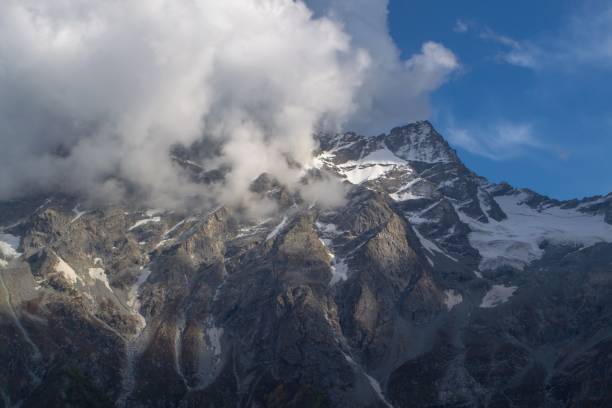 istock Snow capped high mountains alpine meadows and local mountain settlements 1159778107