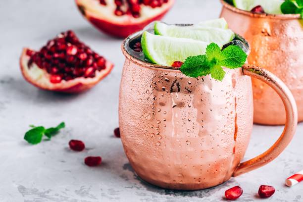istock Iced Cold Moscow Mule cocktail with lime and pomegranate 1159778578