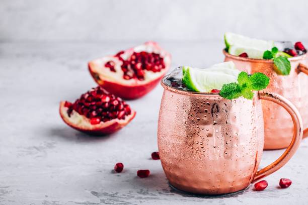 Iced Cold Moscow Mule cocktail with lime and pomegranate