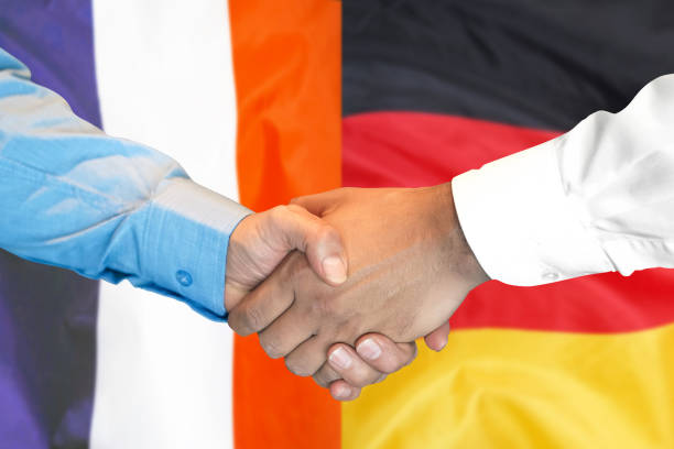 Business handshake on the background of two flags. Men handshake on the background of the France and Germany flag. Support concept