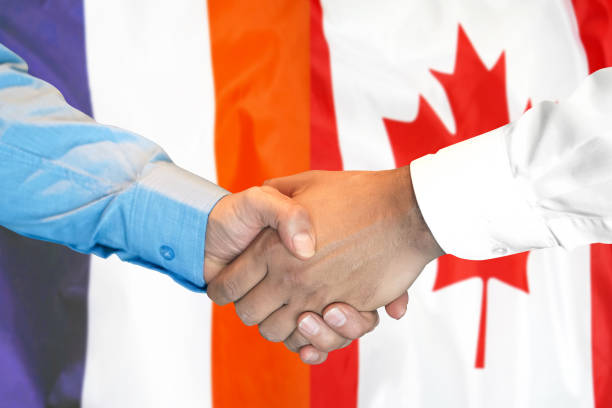 istock handshake on France and Canada flag background. 1159779263