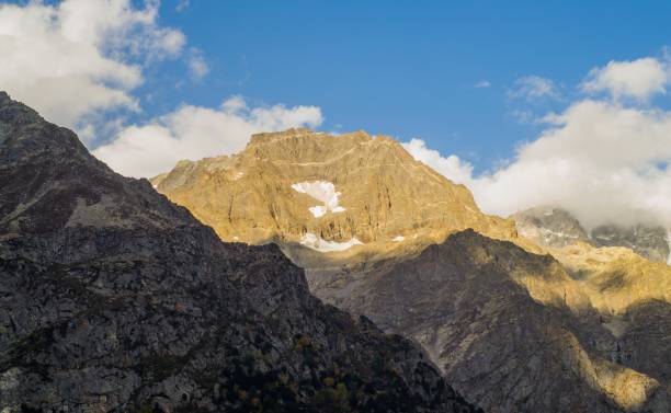 istock Snow capped high mountains alpine meadows and local mountain settlements 1159779423