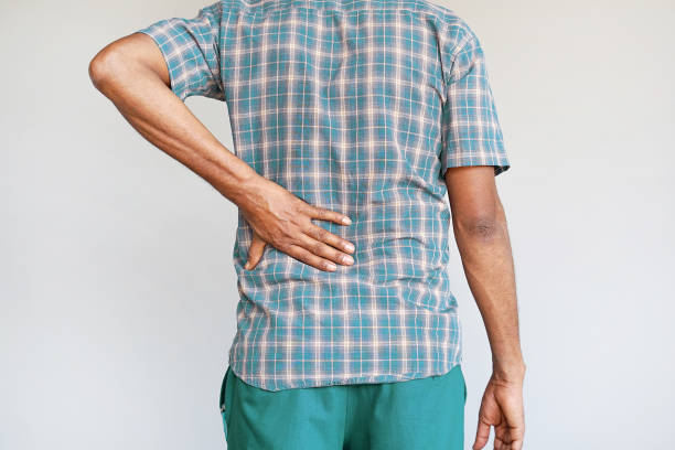 afrikanischer mann, schmerzen am unteren rücken. - pain joint human hand arthritis stock-fotos und bilder