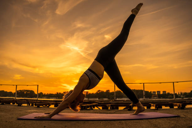 istock Woman exercising yoga in sunset 1159779864