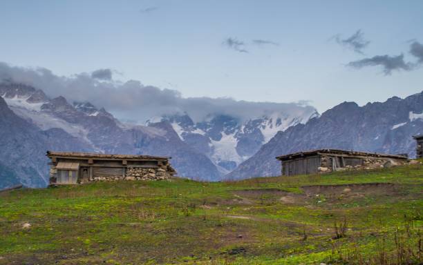 istock Snow capped high mountains alpine meadows and local mountain settlements 1159780670