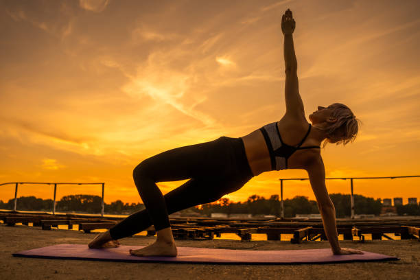 istock Woman practicing pilates in sunset. 1159780716