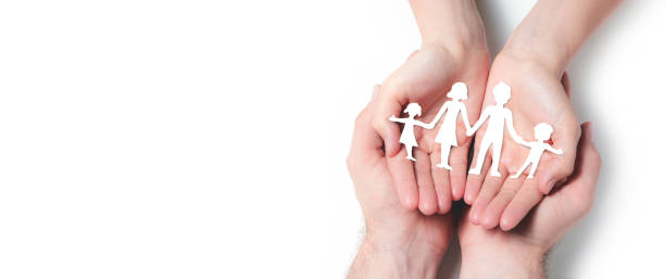 istock Hands Holding Paper Family 1159782059