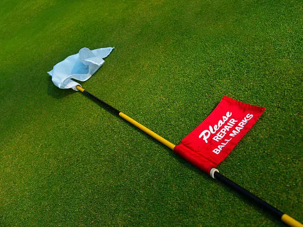 Golf flag. Please repair ball marks. 