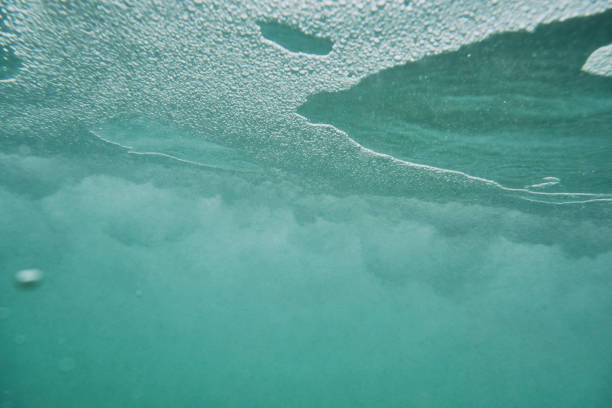 istock Under the sea surface with wild bubbles from a passing overhead breaking wave. 1159783766