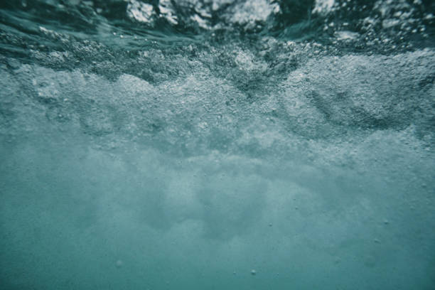 istock Under the sea surface with wild bubbles from a passing overhead breaking wave. 1159783780