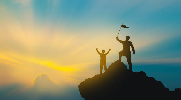 istock Group of people on mountains top in winner pose. Teamwork Concept 1159784075