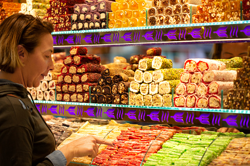 Woman shopping in Turkish delight shop in Grand Bazaar, Istanbul, Turkey.