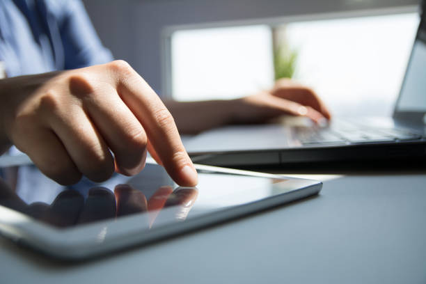 istock Close up of woman hand's using tablet touchscreen 1159786398