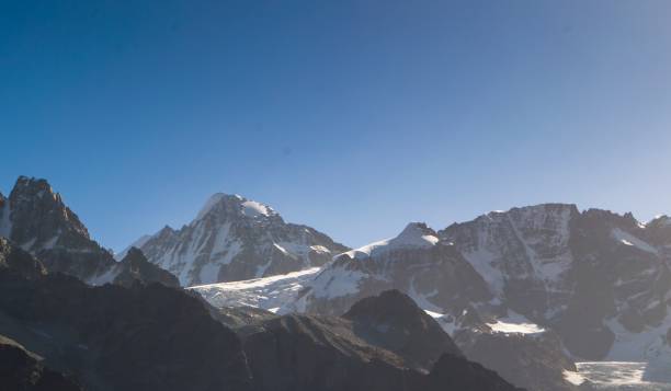 istock Snow capped mountains local settlements alpine meadow and high mountains 1159786538