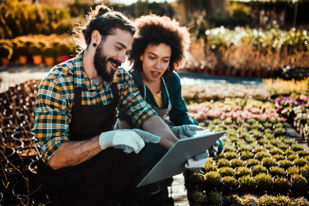 istock Couple looking at tablet in garden 1159786601