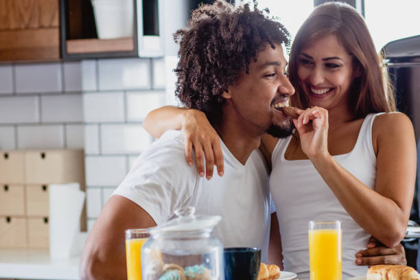 istock young couple is having breakfast in the morning in the kitchen 1159787846