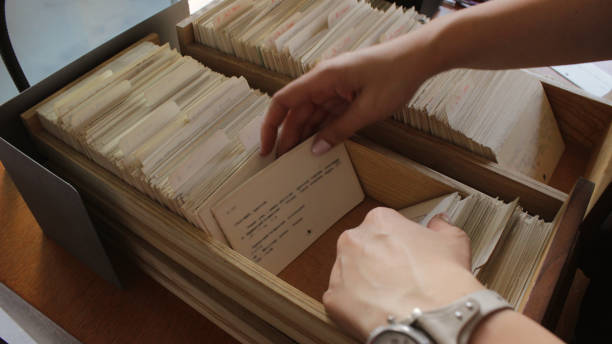 Young woman Librarian labelling books with barcode stickers