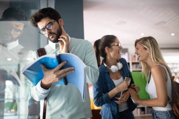 istock Group of friends studying together at university campus 1159789980