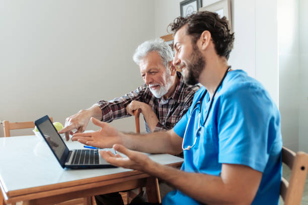 istock Male Caretaker Using Laptop while Explaining Prescription to Senior Man 1159791427