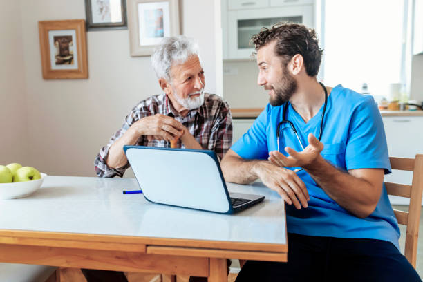 istock Male Caretaker Using Laptop while Explaining Prescription to Senior Man 1159791448