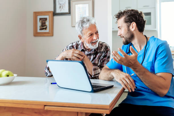istock Male Caretaker Using Laptop while Explaining Prescription to Senior Man 1159791491