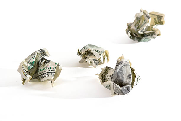 istock crumpled dollar's paper as symbol of SCAM 115979161
