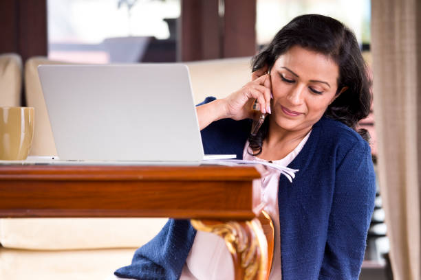 istock Businesswoman talking on mobile phone 1159792700