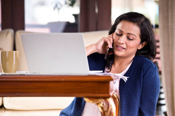 istock Businesswoman talking on mobile phone 1159792833