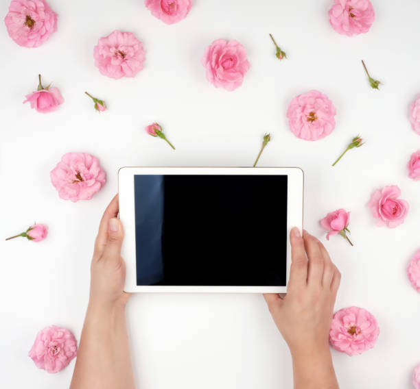 istock electronic tablet with a blank black screen and two female hands holding device 1159792966
