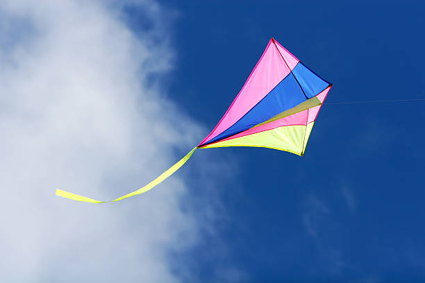 istock Colorful kite flying with a blue sky and cloud above 115979391
