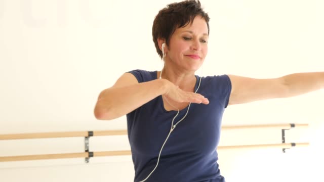 Woman enjoying music and practicing dance in class
