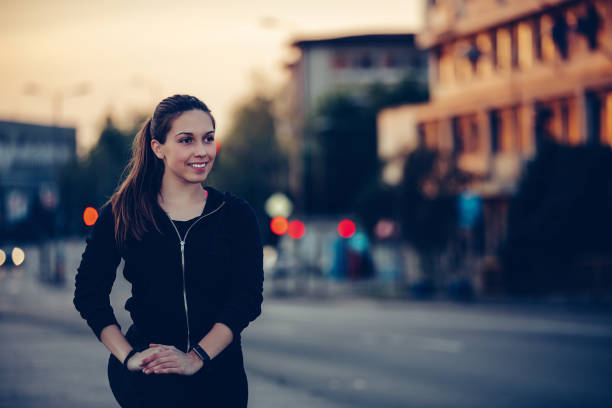 istock Beautiful girl doing stretching exercise on the bridge, at night 1159795824