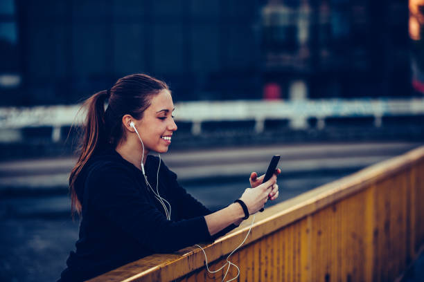istock Young woman relaxing after jogging, at night 1159795849