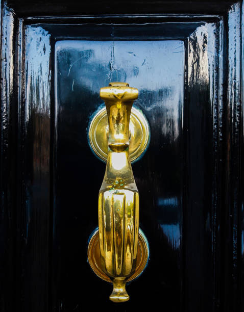 istock Bronze hand on  a Black Door 1159797142