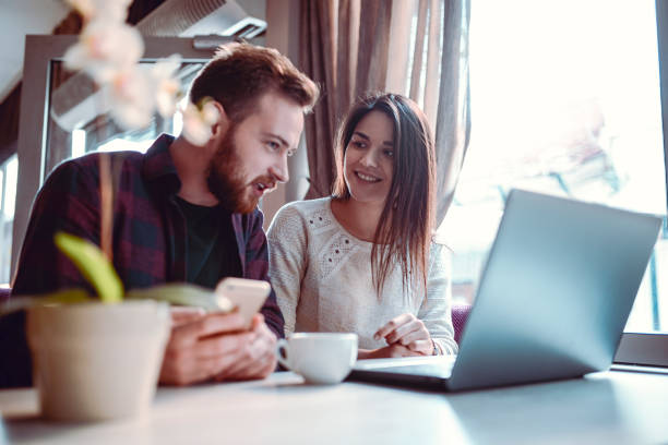 istock Couple Looking At Catalogues While Drinking Coffee In Restaurant 1159798133