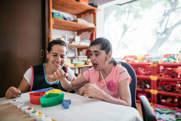 istock Working in nursery with Down Syndrome children 1159798217
