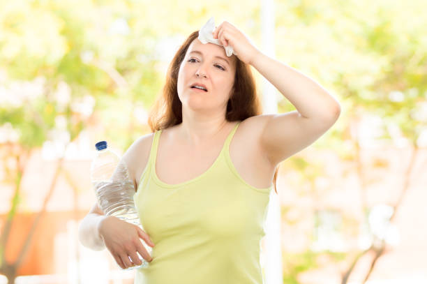 istock woman sweating suffering a heat stroke 1159798834
