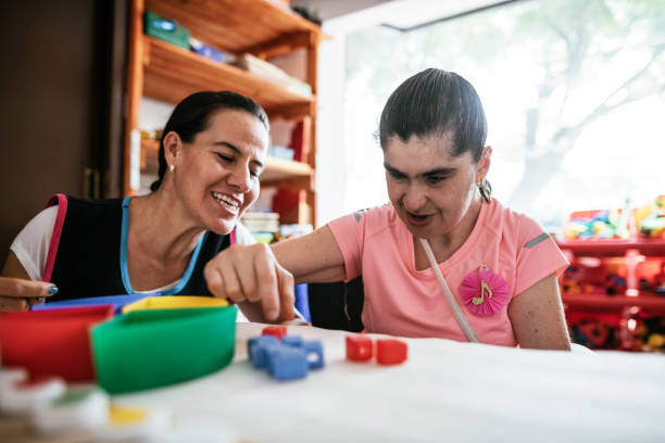 istock Playing with Down Syndrome mature woman 1159798925