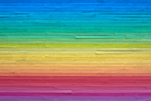Building siding painted in rainbow colors.