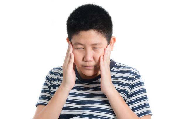 istock Asian preteen boy having headace on white background. 1159799171